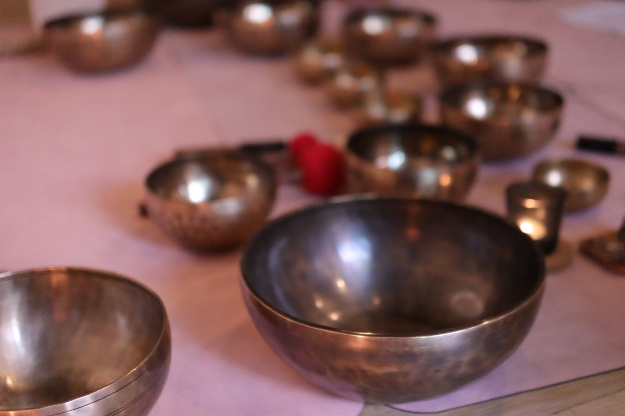Hand-hammered Tibetan singing bowls laid out for a session