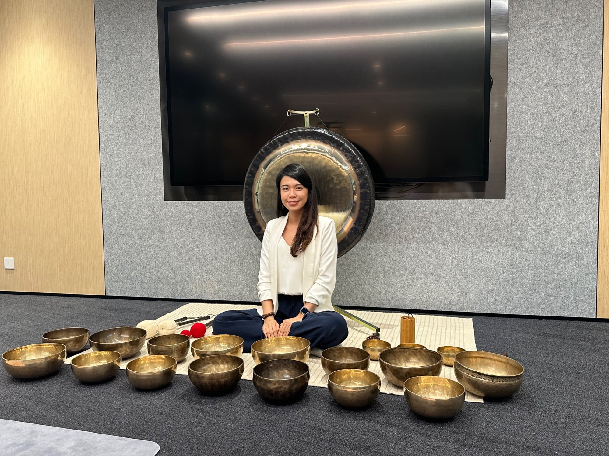 Helen with a gong and singing bowls at Allianz Global Investors