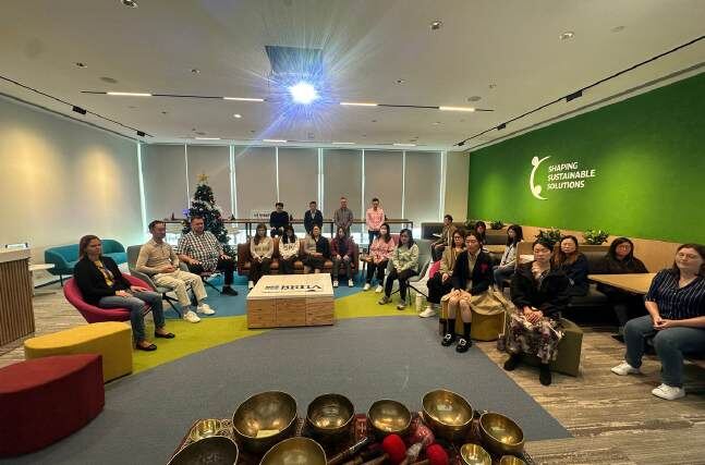 Team gathered around singing bowls