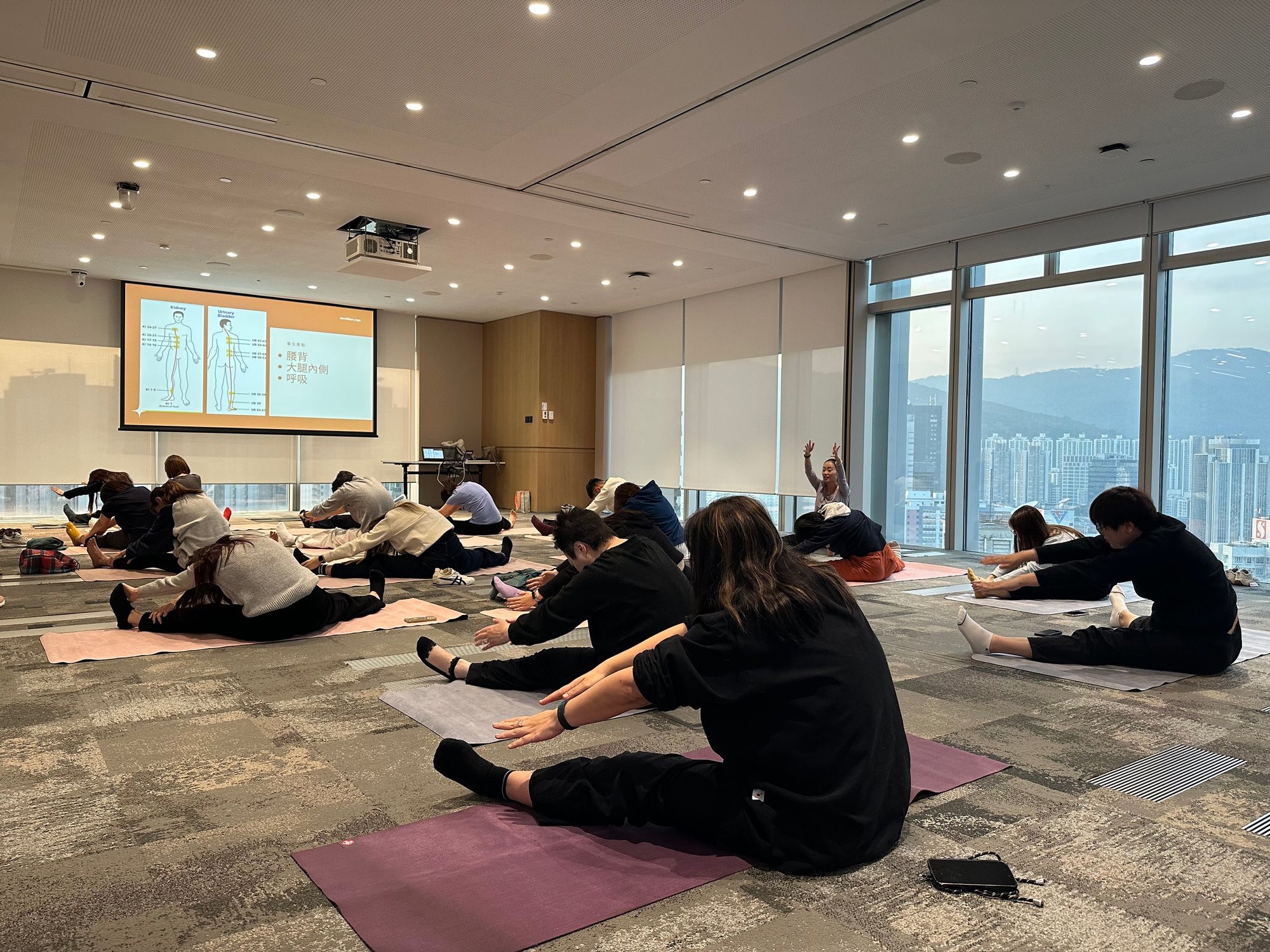 Helen leading yoga for the Chinachem Group team