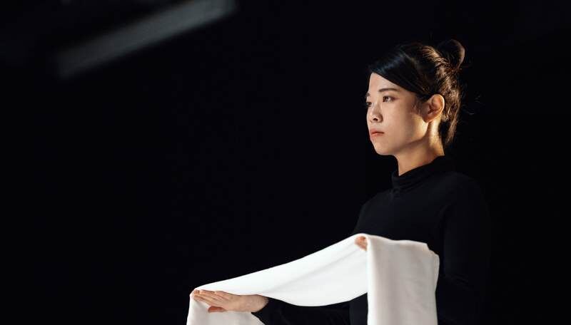 Helen in profile holding white cloth