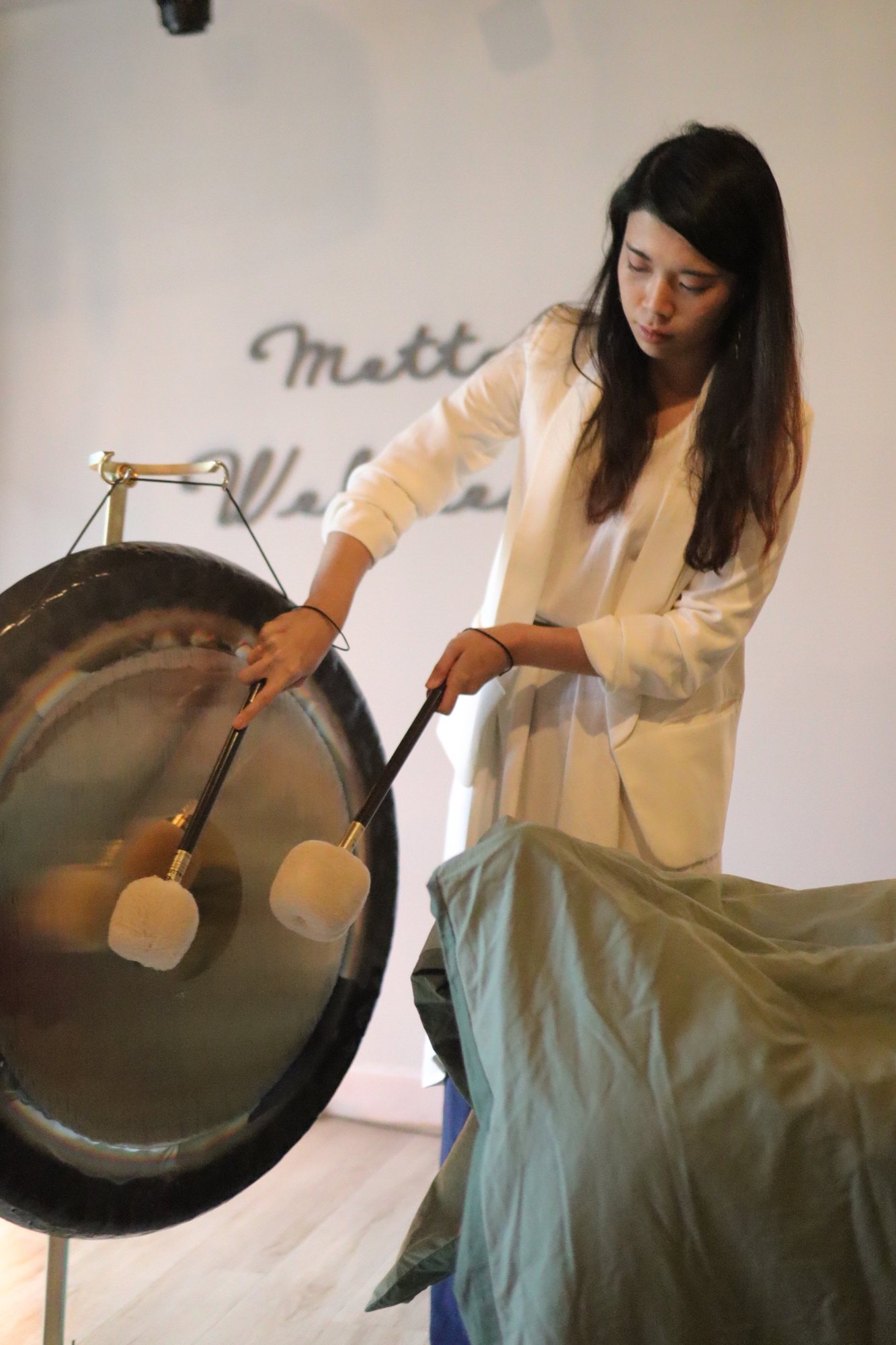 Helen playing the gong in her Hong Kong studio