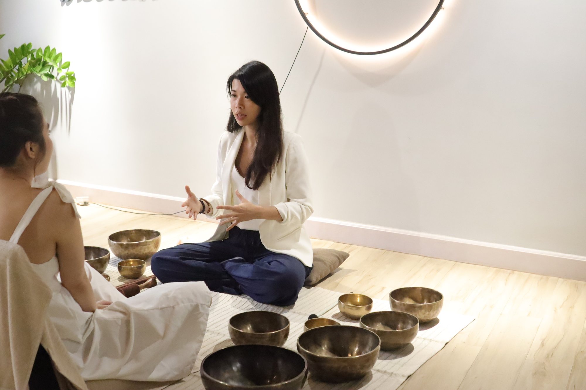 Helen guiding a guest through the singing bowls