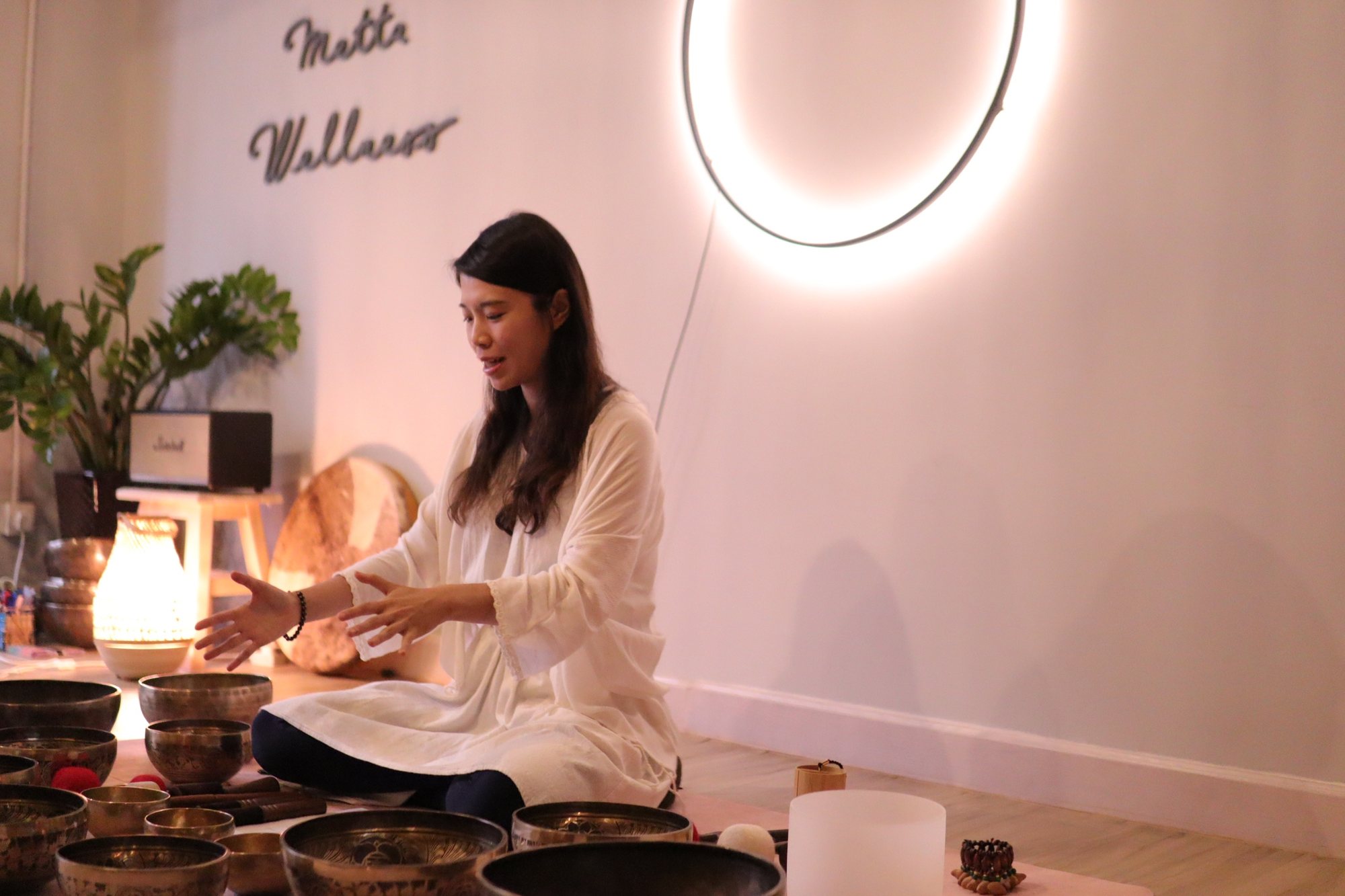 Helen teaching among singing bowls in her studio