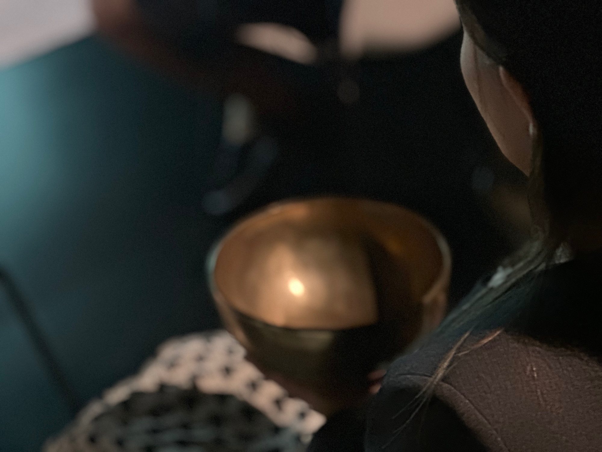 Students listening to singing bowls in a university session